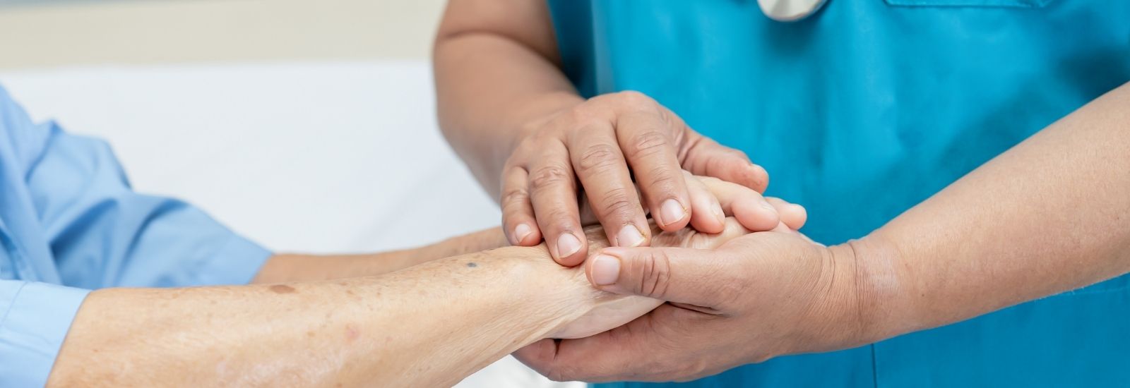 doctor holding patient's hands