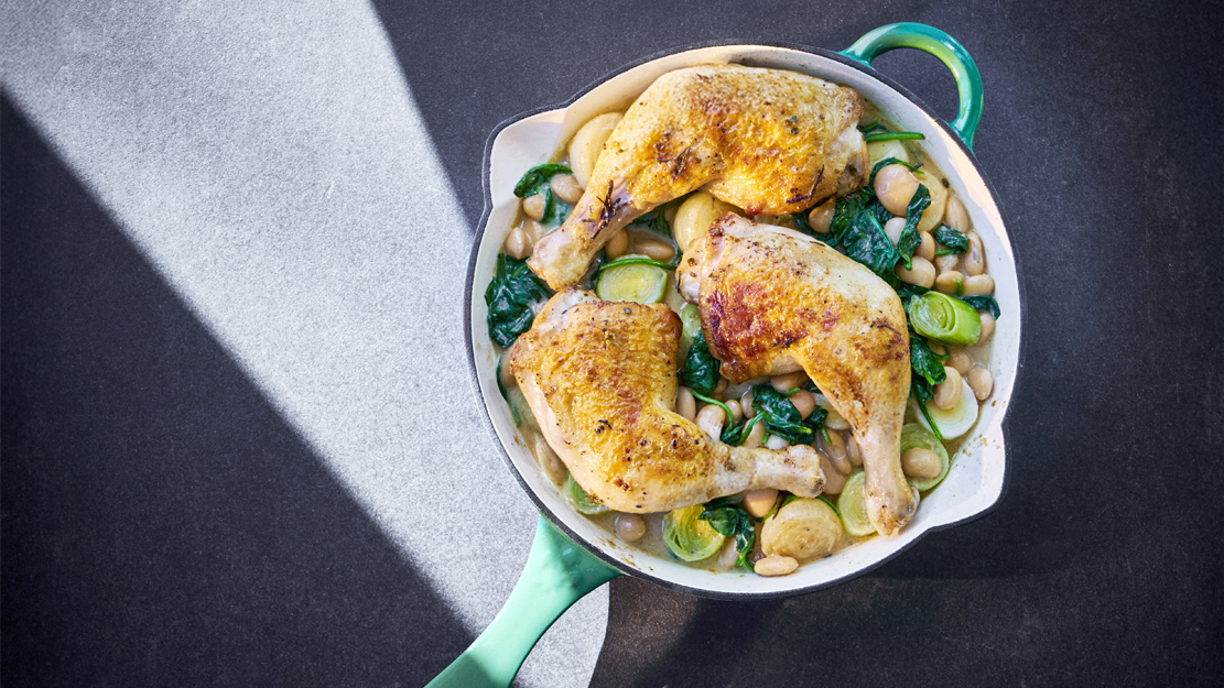 Roasted chicken with butter beans, leeks and baby onions