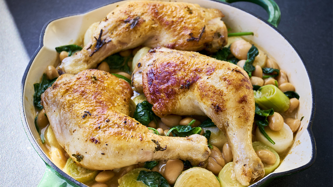 Roasted chicken with butter beans, leeks and baby onions